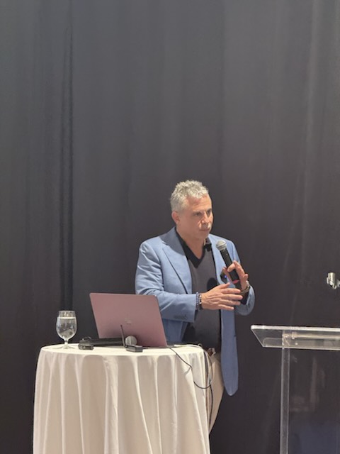 A speaker presenting at the podium