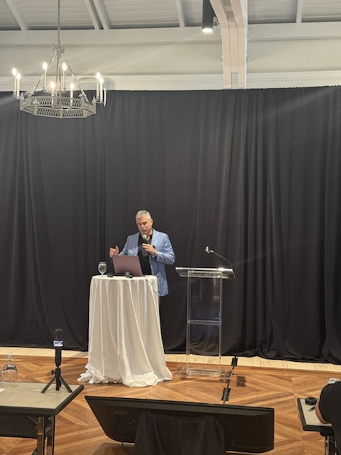 A speaker presenting in the conference room