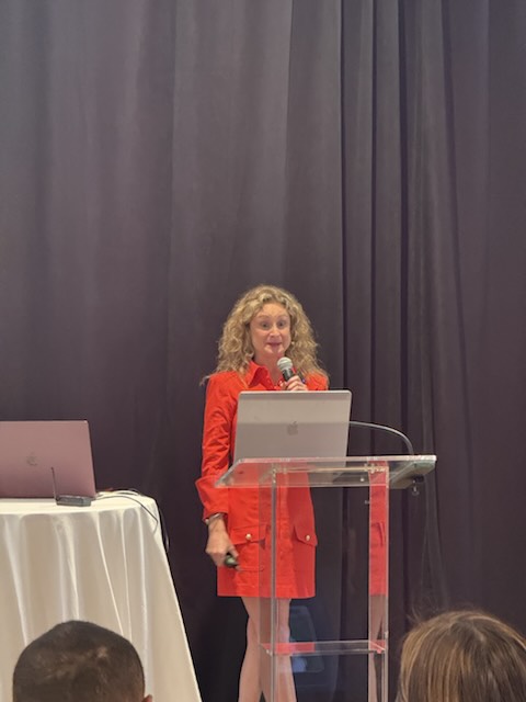 A speaker presenting at the podium